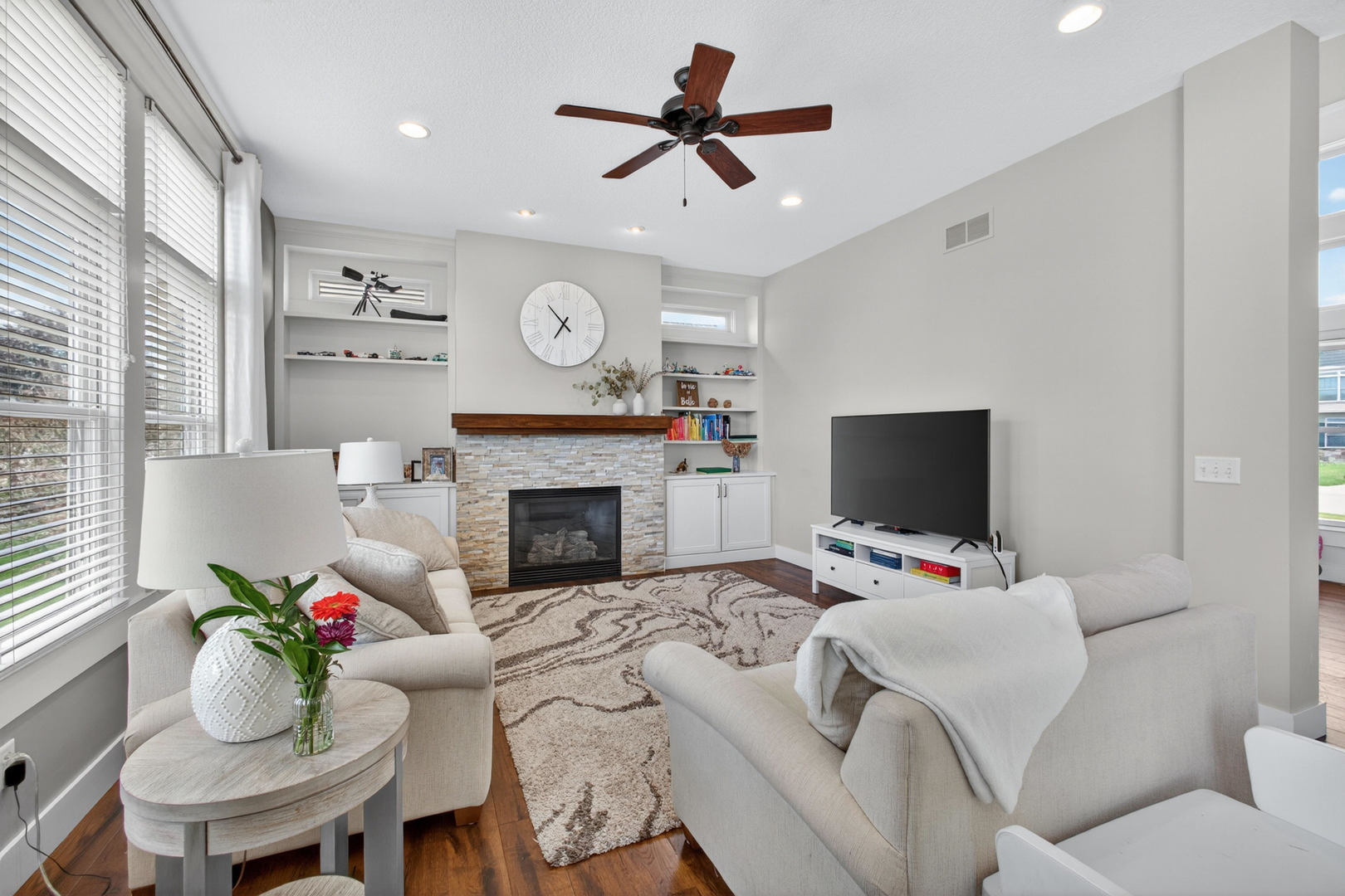 5700 Emily Road Bettendorf, IA 52722 - Photo 8 of 58 a living room with furniture a fireplace and a flat screen tv