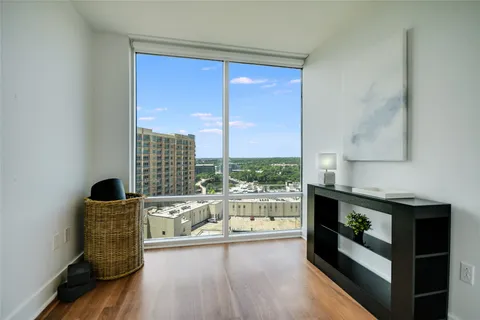 a living room with furniture and a floor to ceiling window