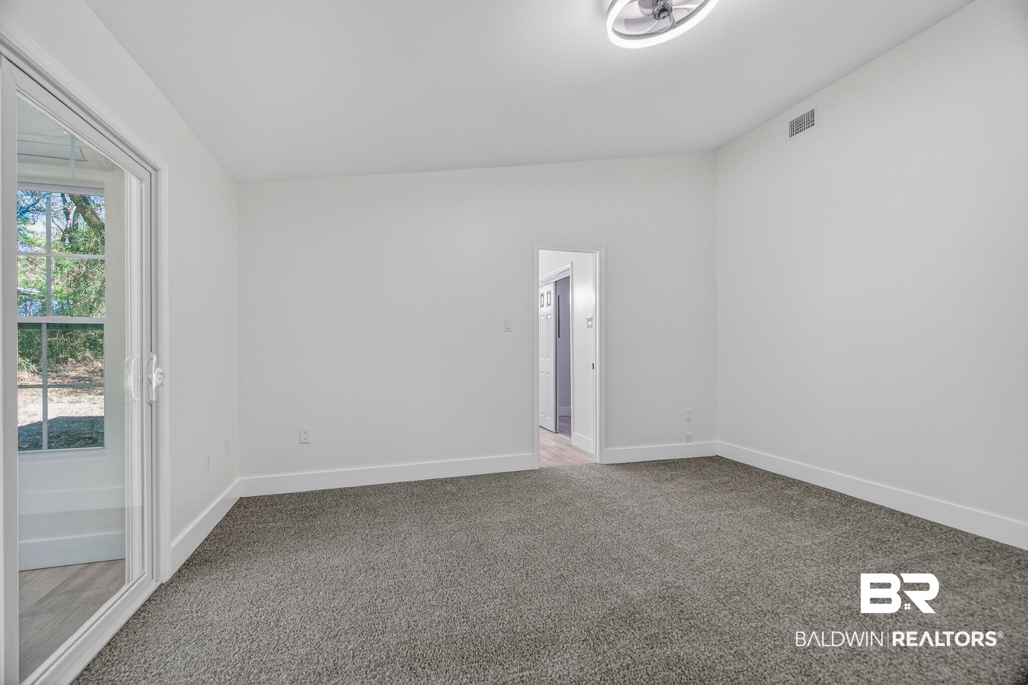 10650 Old Pascagoula Road Theodore, AL 36582 - Photo 64 of 77 Spare room with light carpet and baseboards