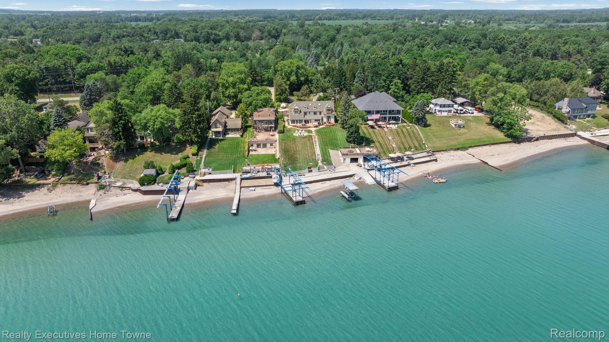 8308 Lakeshore Road Fort Gratiot, MI 48059 - Photo 30 of 79 Waterfront property featuring a private boat lift, multiple docks, and a sandy beach