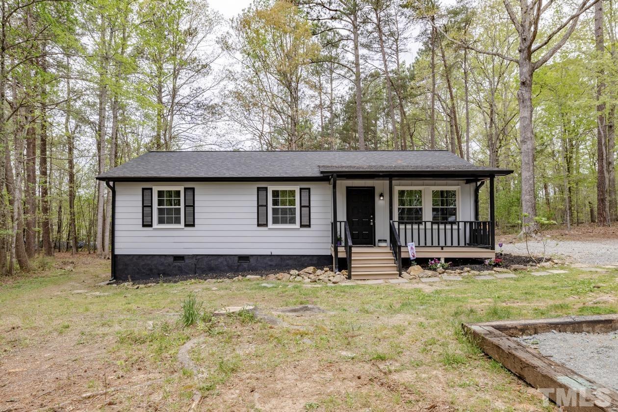 6803 Russell Road Durham, NC 27712 - Photo 1 of 27 a front view of a house with a yard