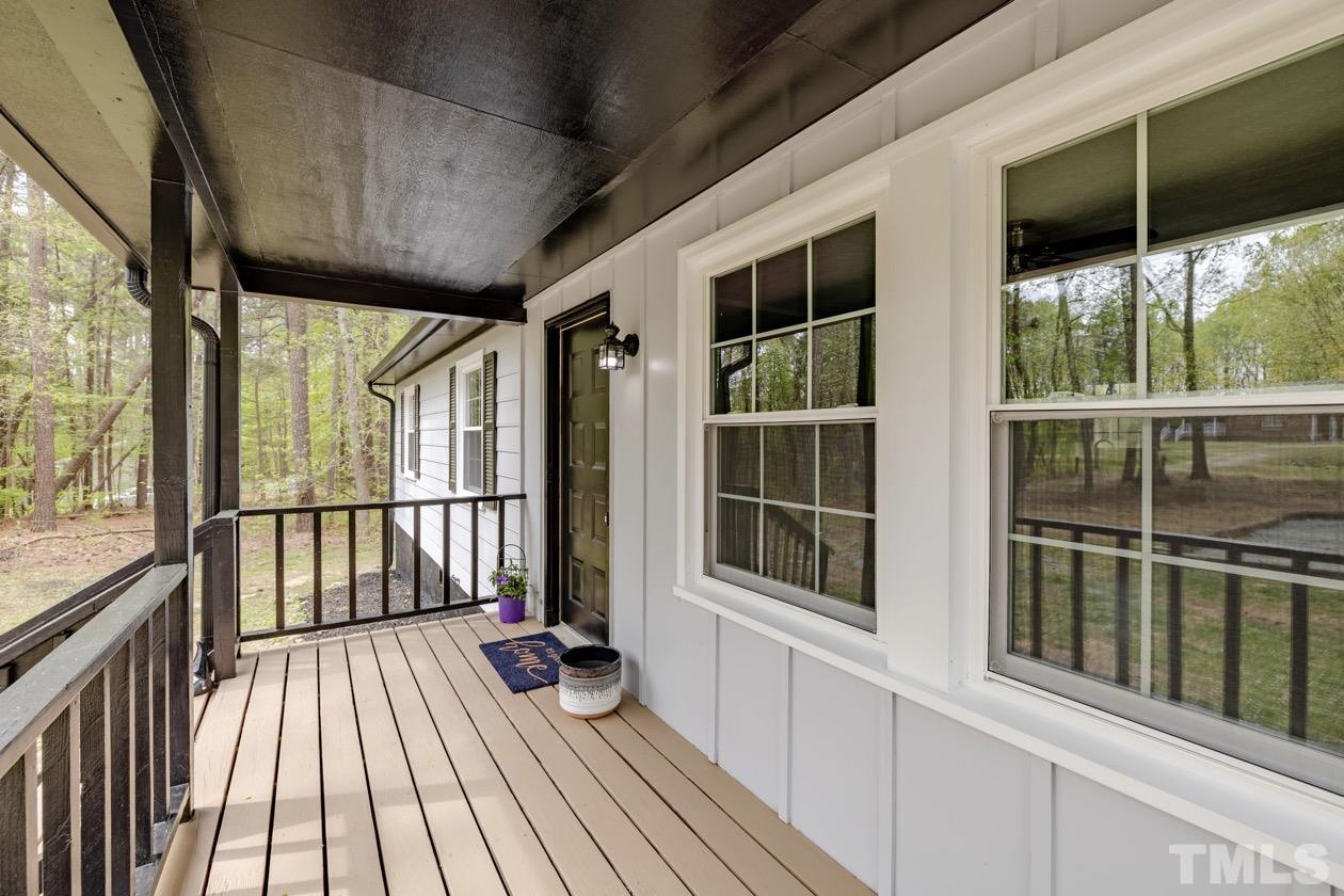 6803 Russell Road Durham, NC 27712 - Photo 2 of 27 a view of a balcony with wooden floor
