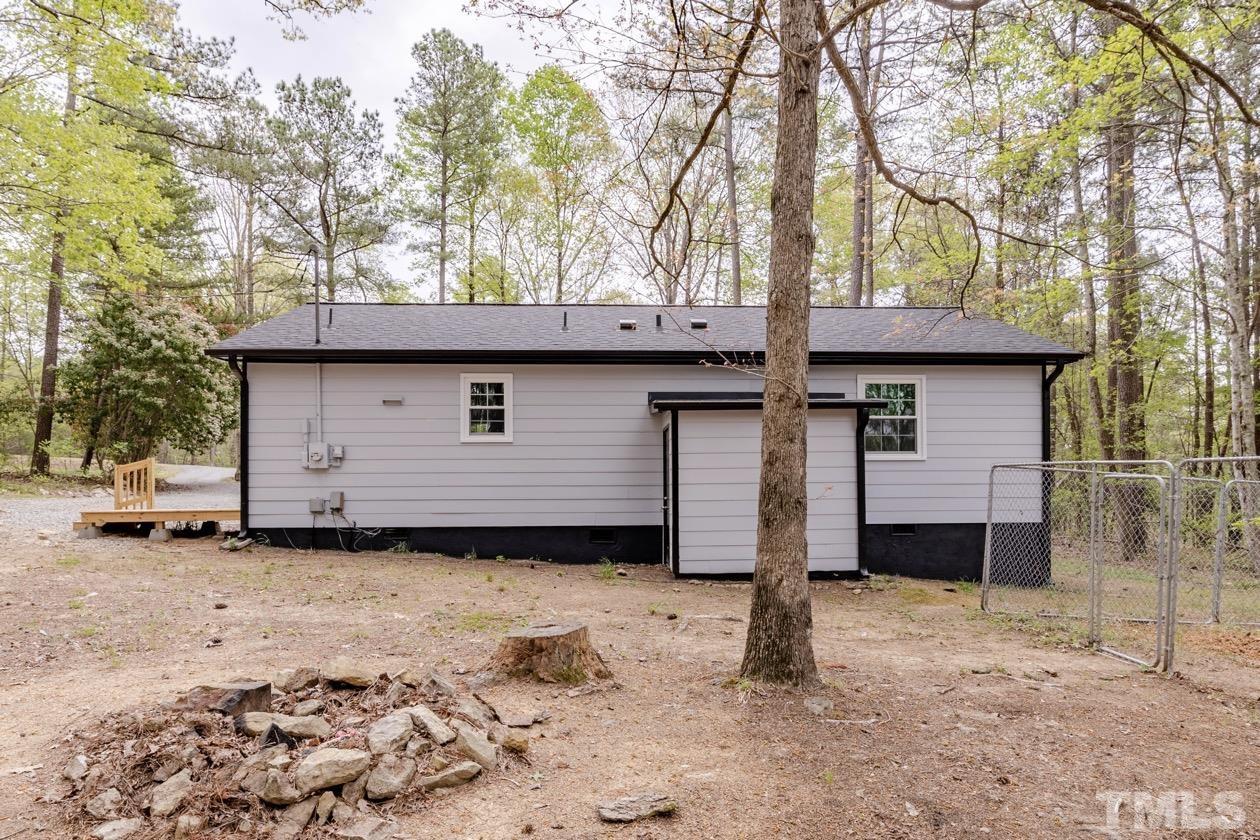 6803 Russell Road Durham, NC 27712 - Photo 22 of 27 a front view of a house with a yard