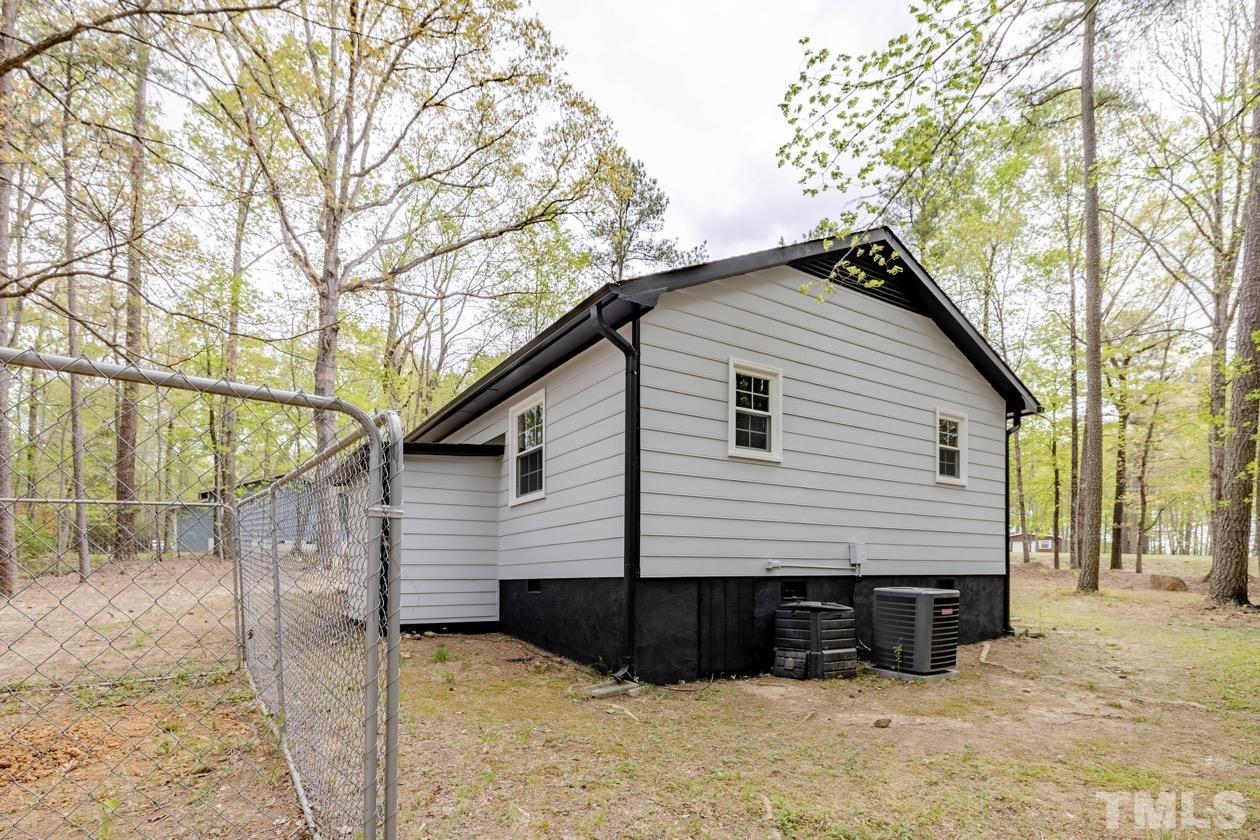 6803 Russell Road Durham, NC 27712 - Photo 23 of 27 a view of a house with a yard
