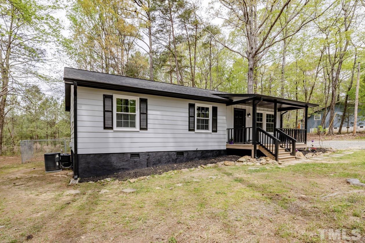 6803 Russell Road Durham, NC 27712 - Photo 25 of 27 front view of a house with a yard