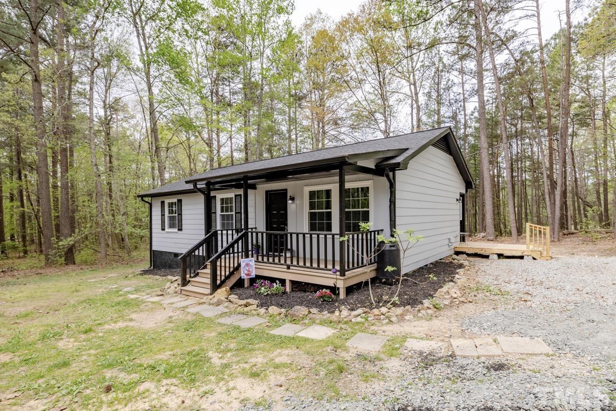 6803 Russell Road Durham, NC 27712 - Photo 26 of 27 a view of a house with a yard and wooden fence
