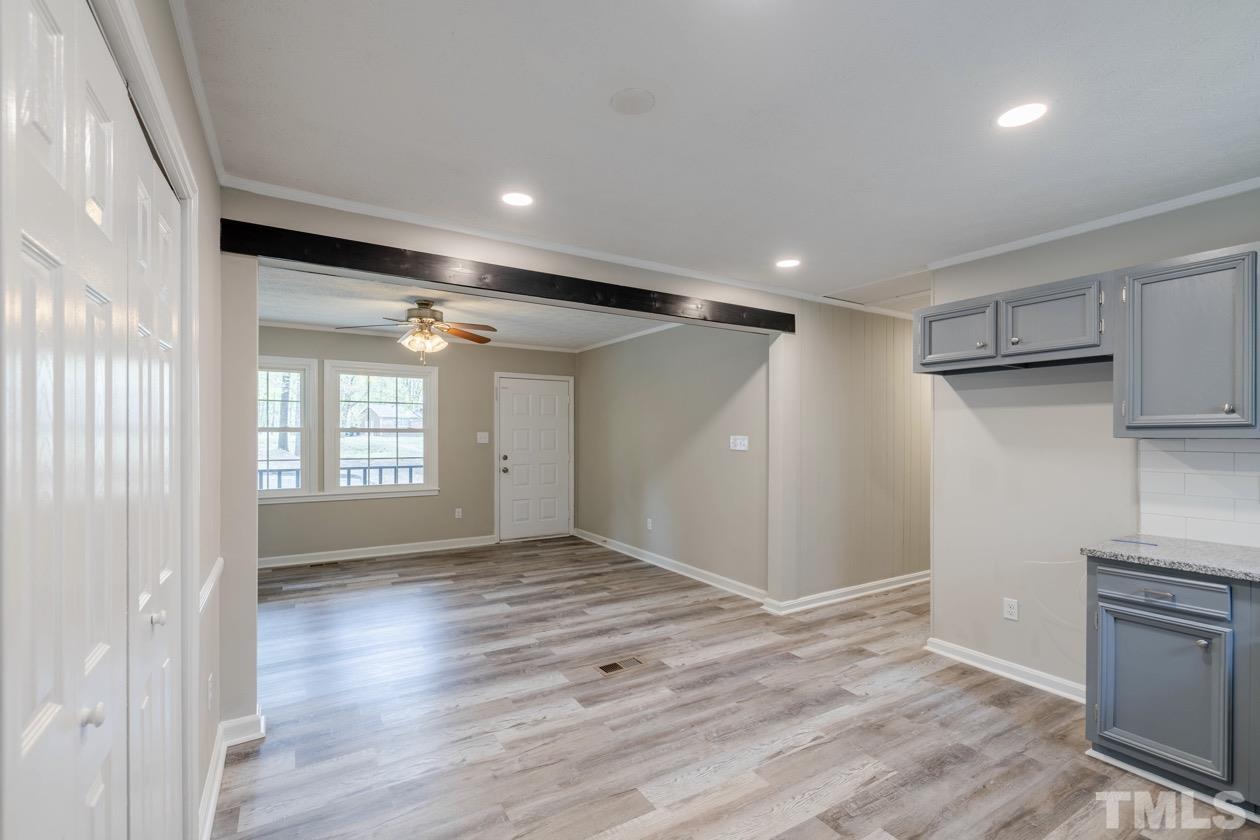 6803 Russell Road Durham, NC 27712 - Photo 10 of 27 a view of empty room with wooden floor and fan