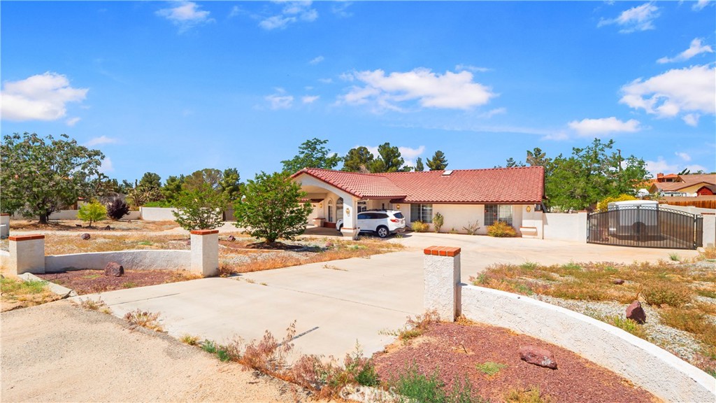 13116 Rincon Road Apple Valley, CA 92308 - Photo 1 of 62 a view of a swimming pool with a lounge chairs