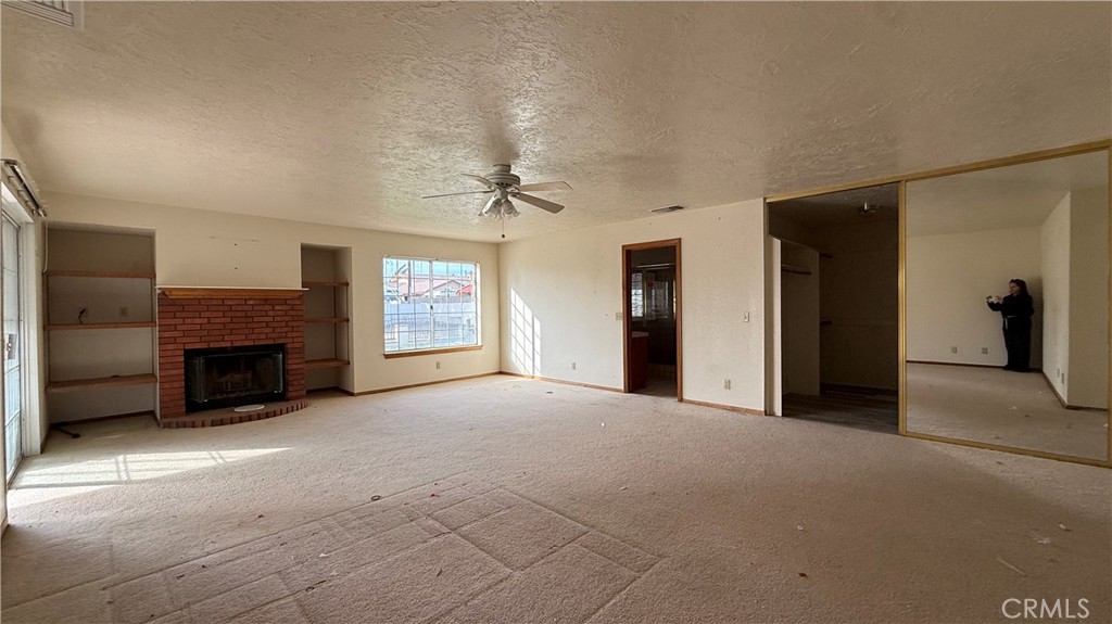 13116 Rincon Road Apple Valley, CA 92308 - Photo 18 of 62 a view of a livingroom with a fireplace and window