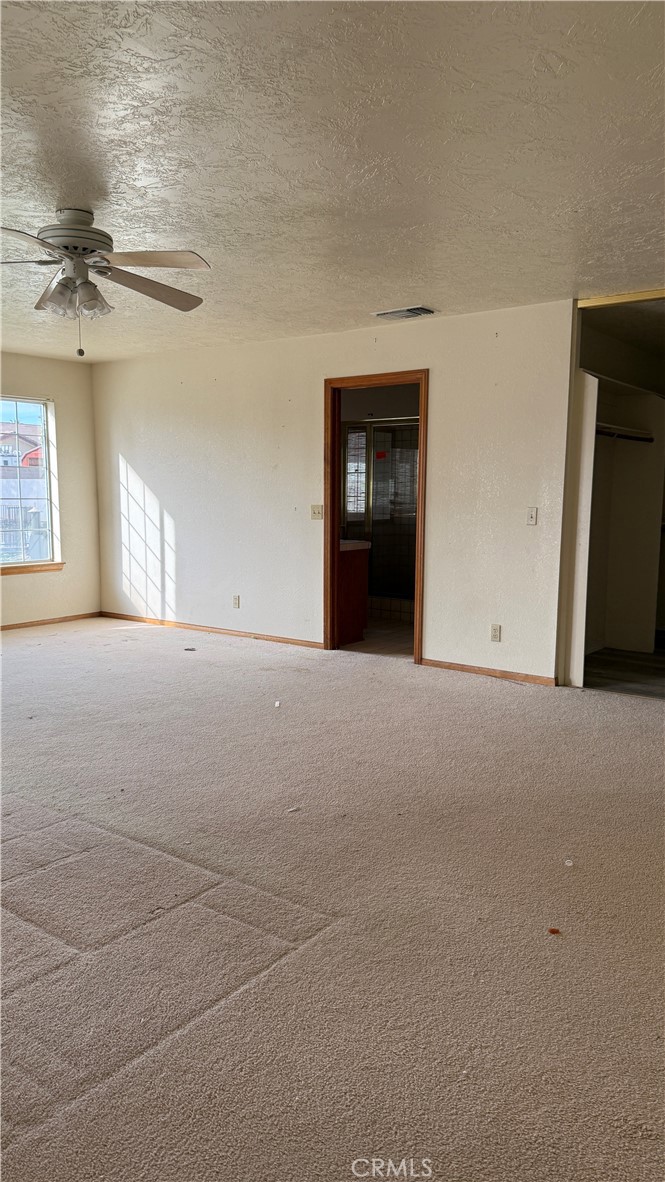 13116 Rincon Road Apple Valley, CA 92308 - Photo 21 of 62 a view of empty room with windows