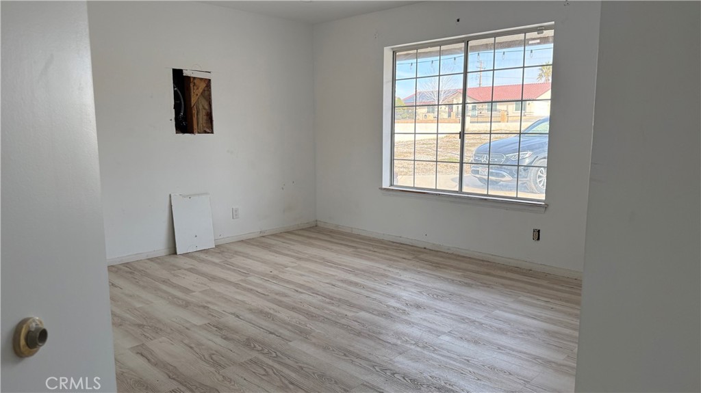 13116 Rincon Road Apple Valley, CA 92308 - Photo 30 of 62 a view of empty room with wooden floor and fan