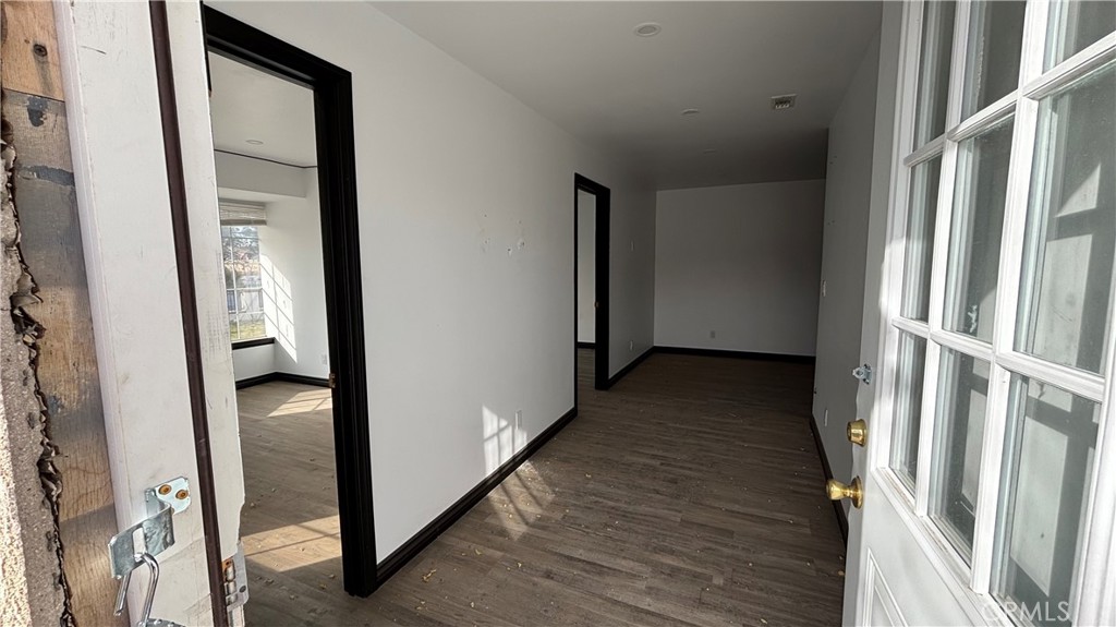 13116 Rincon Road Apple Valley, CA 92308 - Photo 36 of 62 a view of a hallway with wooden floor and staircase