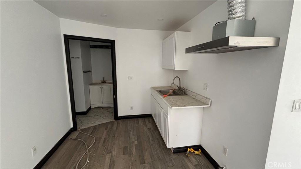 13116 Rincon Road Apple Valley, CA 92308 - Photo 39 of 62 a kitchen with a sink a refrigerator and wooden floor