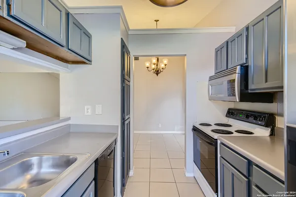 a kitchen that has a sink and a stove