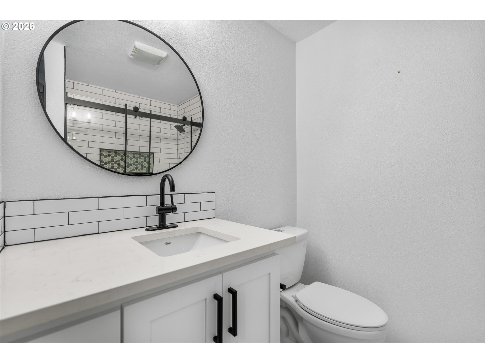 602 South Vermont Street Portland, OR 97219 - Photo 12 of 46 a bathroom with a toilet a sink and a mirror