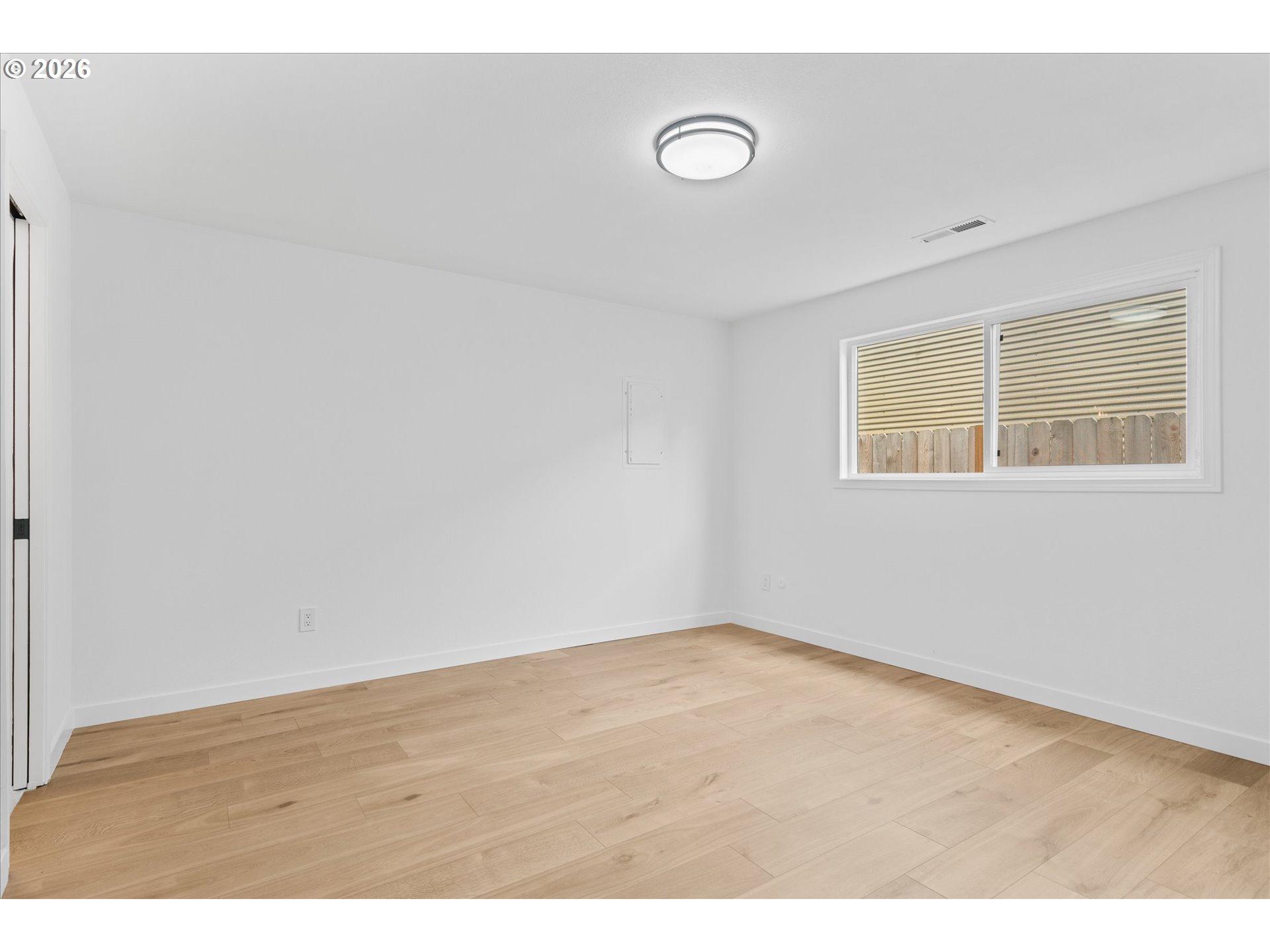 602 South Vermont Street Portland, OR 97219 - Photo 15 of 46 a view of an empty room with wooden floor and a window