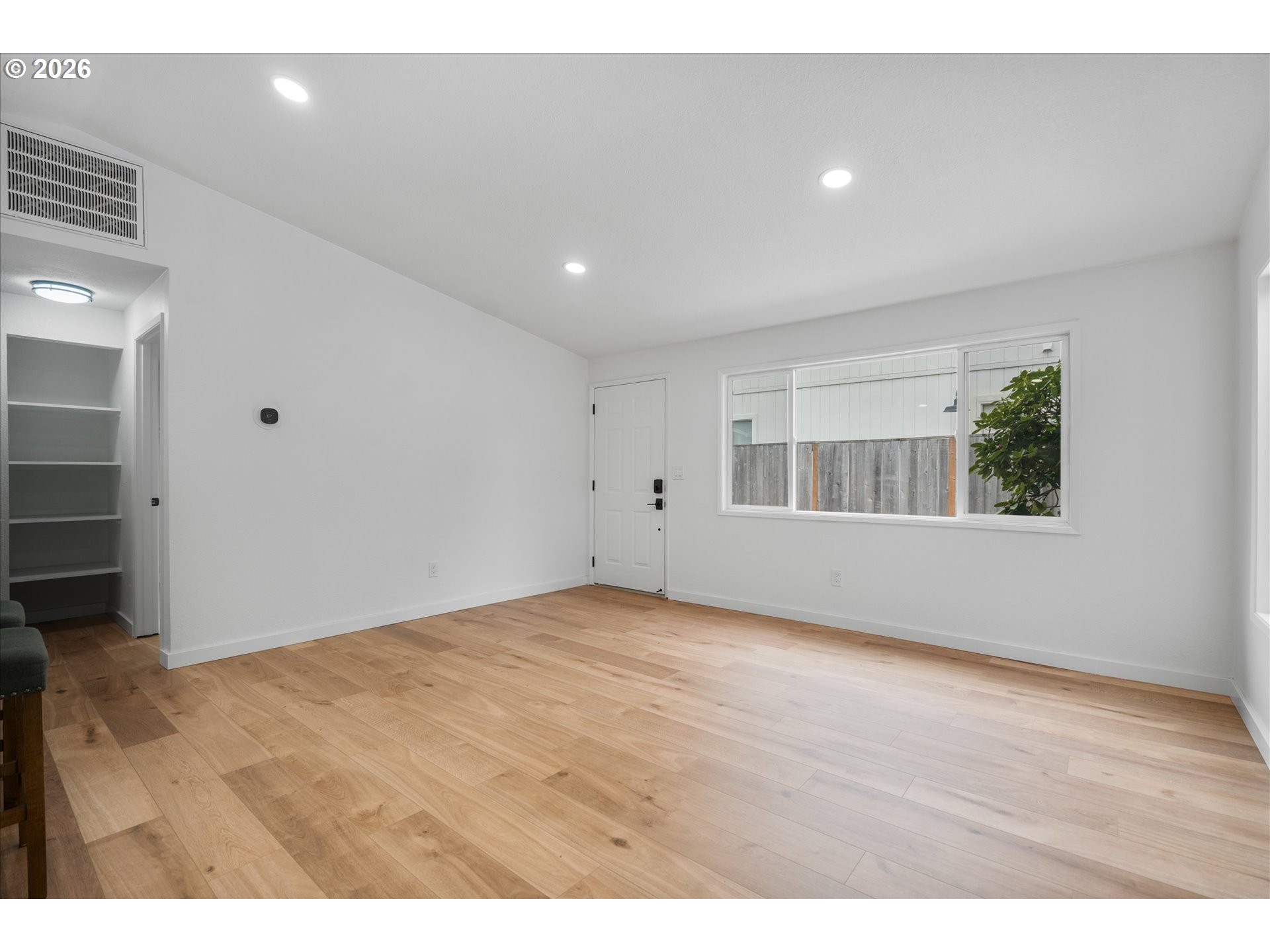 602 South Vermont Street Portland, OR 97219 - Photo 21 of 46 a view of an empty room with wooden floor and a window
