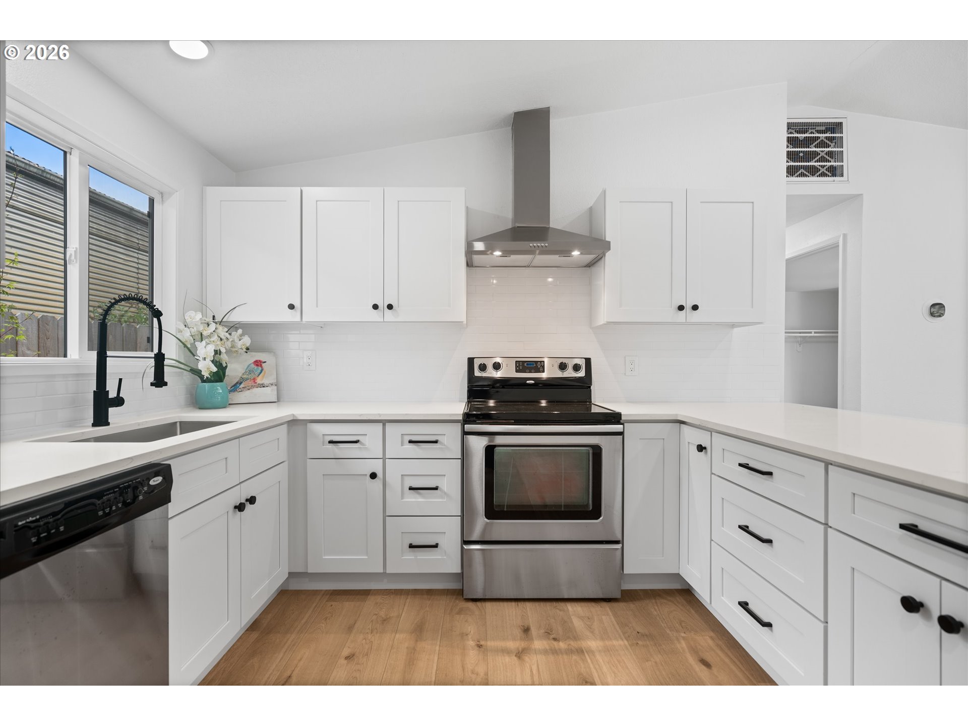 602 South Vermont Street Portland, OR 97219 - Photo 26 of 46 a kitchen with appliances cabinets and a sink
