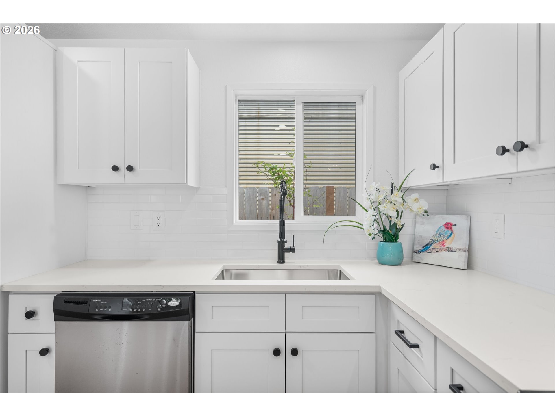 602 South Vermont Street Portland, OR 97219 - Photo 27 of 46 a kitchen with white cabinets and a window