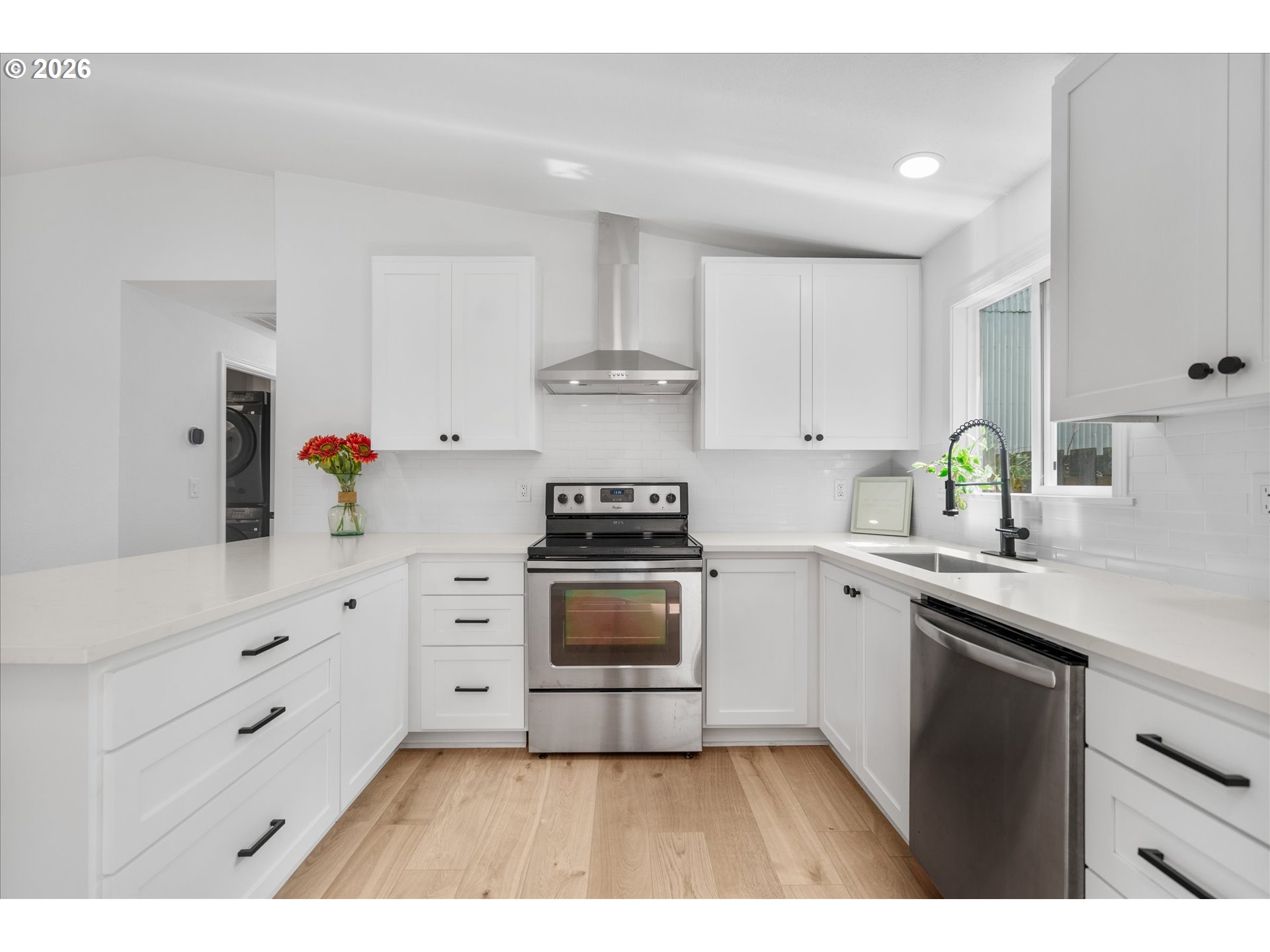602 South Vermont Street Portland, OR 97219 - Photo 7 of 46 a kitchen with cabinets appliances a sink and a counter top