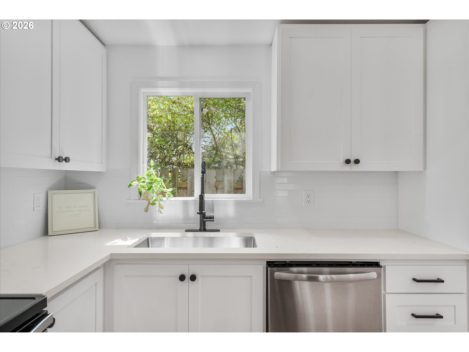 602 South Vermont Street Portland, OR 97219 - Photo 8 of 46 a kitchen with stainless steel appliances white cabinets and a window