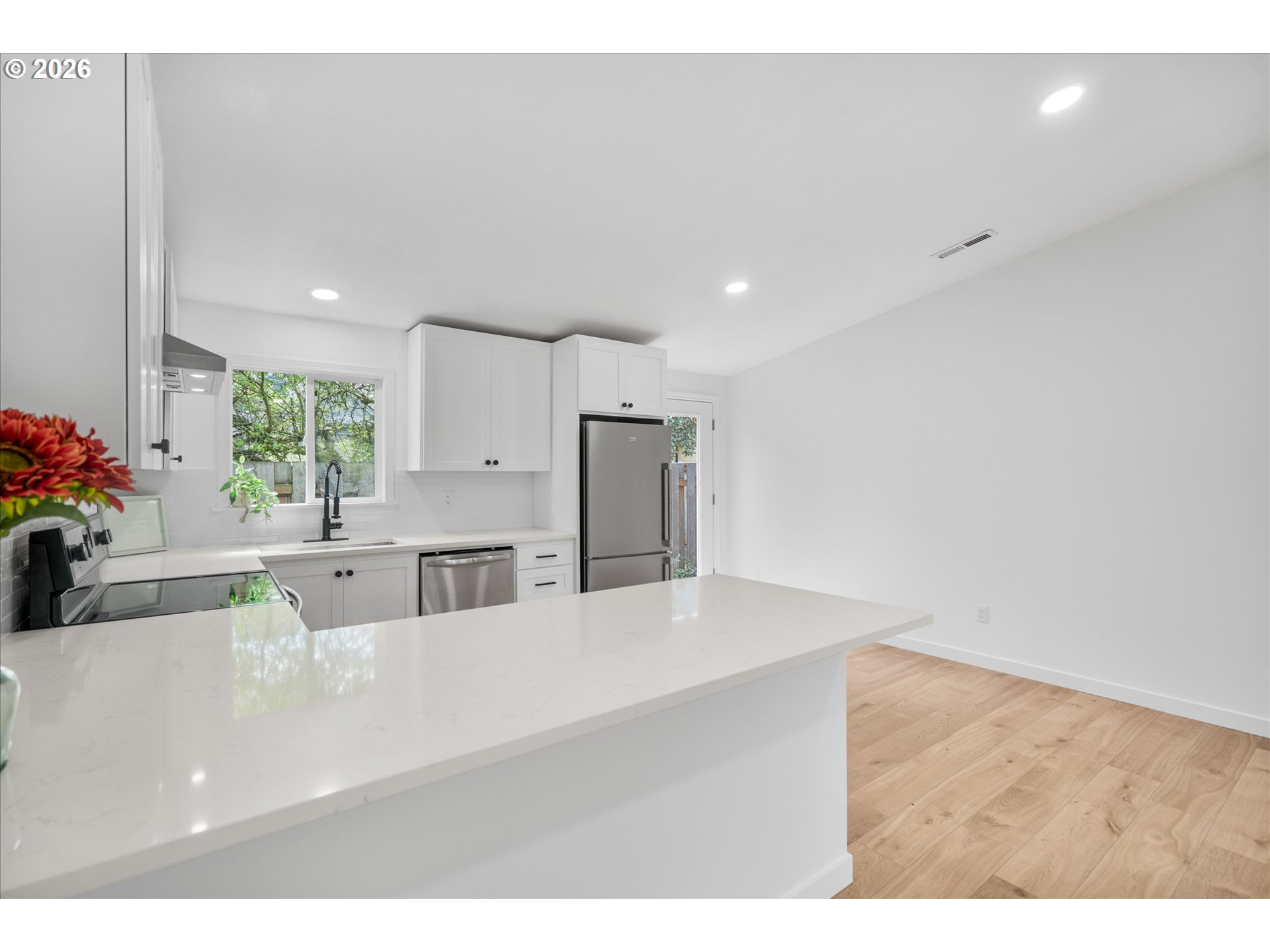 602 South Vermont Street Portland, OR 97219 - Photo 9 of 46 a kitchen with kitchen island a counter top space a sink stainless steel appliances and cabinets