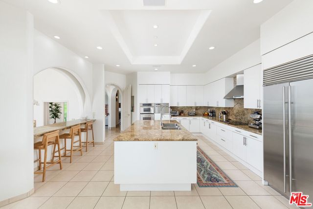 a living room with furniture fireplace and a large window