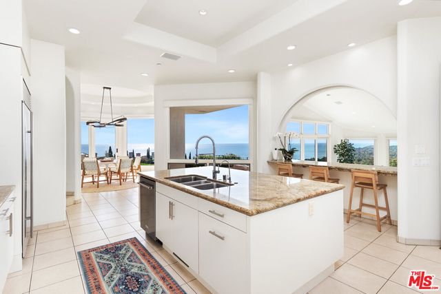 a living room with furniture fireplace and potted plants