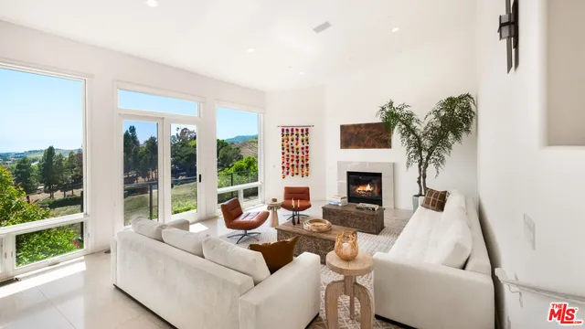 a large white bathroom with a large tub sink and window