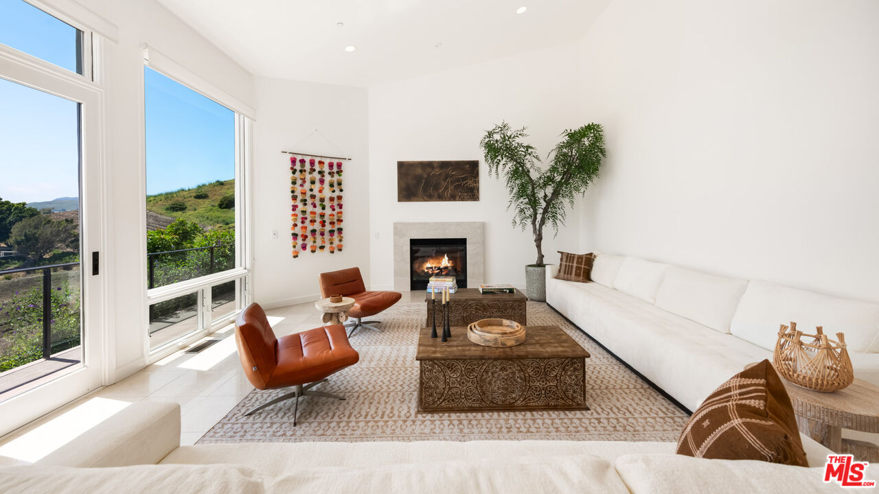 27445 Winding Way Malibu, CA 90265 - Photo 35 of 59 a living room with furniture fireplace and potted plants