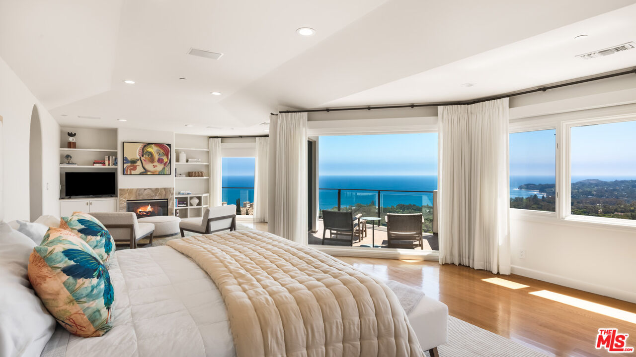 27445 Winding Way Malibu, CA 90265 - Photo 38 of 59 a bedroom with a bed large window and couch
