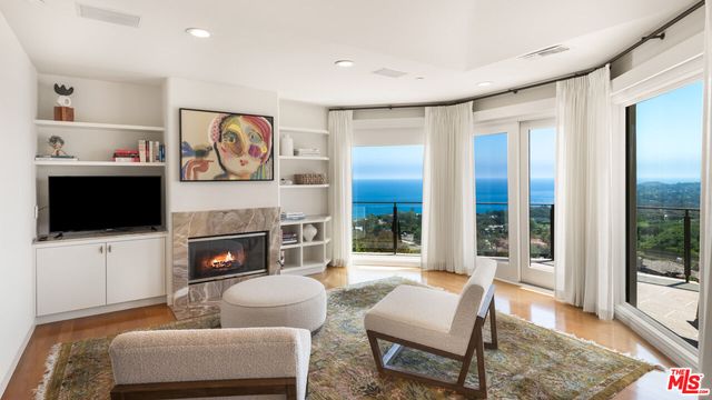 a bedroom with a bed and glass window