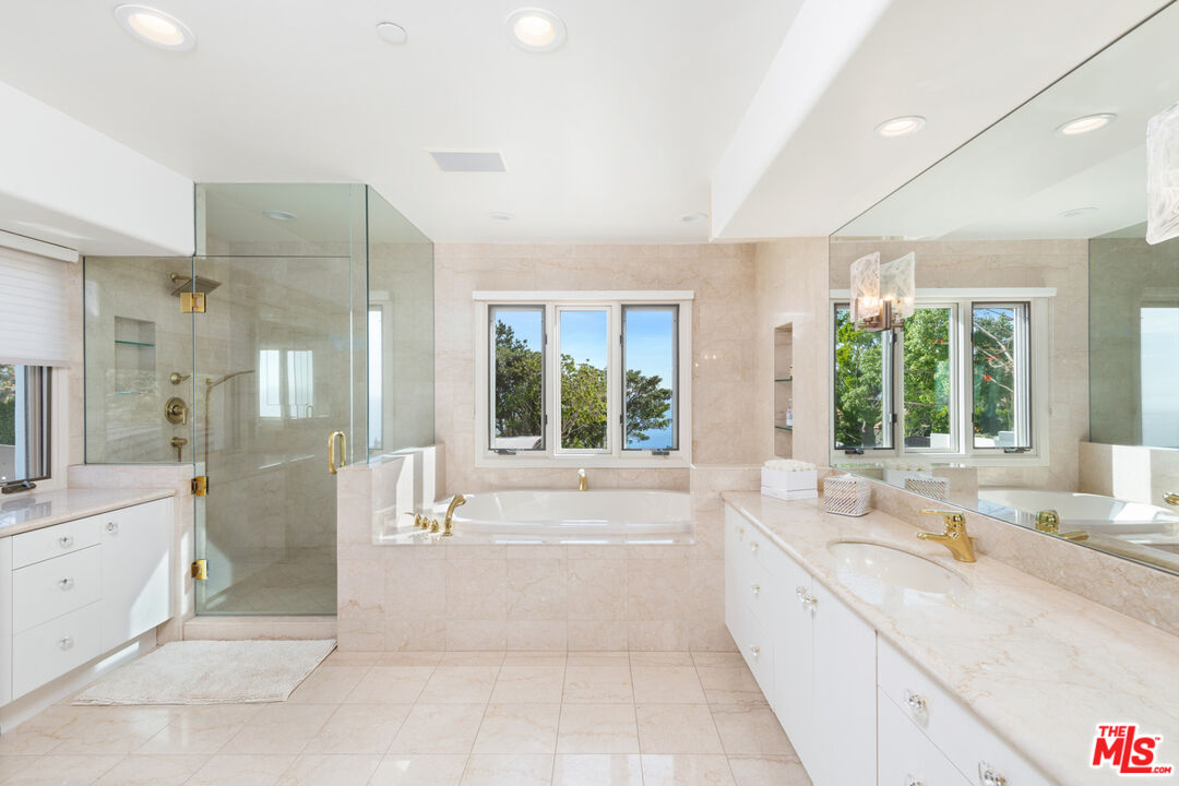 27445 Winding Way Malibu, CA 90265 - Photo 42 of 59 a large white bathroom with a large tub sink and window