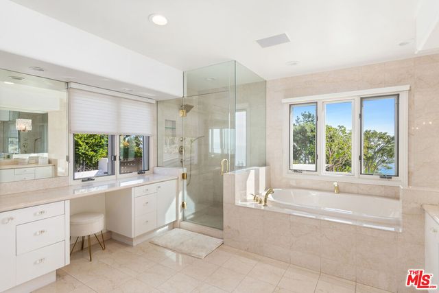 a bedroom with a large bed and a large window