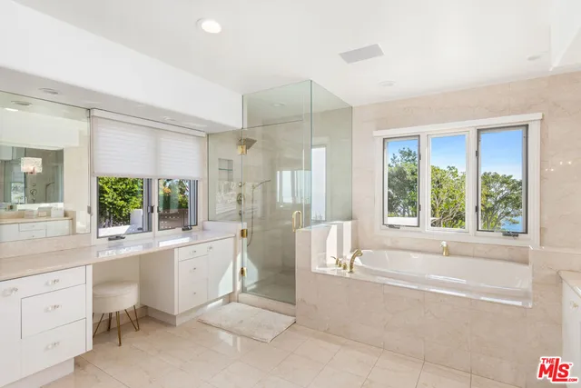 a bedroom with a large bed and a large window