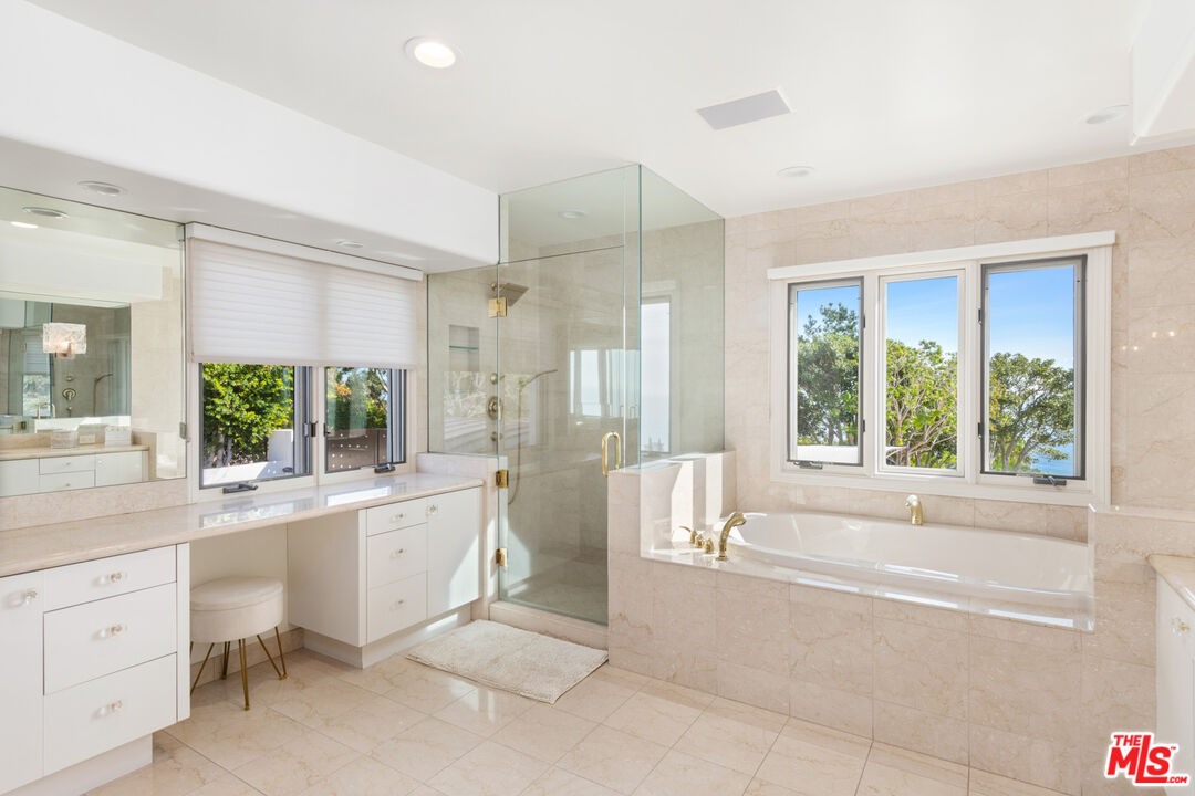 27445 Winding Way Malibu, CA 90265 - Photo 43 of 59 a large white tub sitting in a bathroom next to a large window