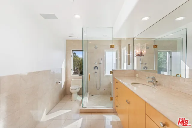 a bathroom with a granite countertop sink a mirror and a window