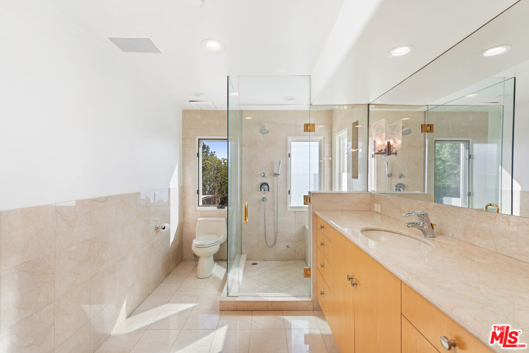27445 Winding Way Malibu, CA 90265 - Photo 44 of 59 a bathroom with a tub sink shower and mirror