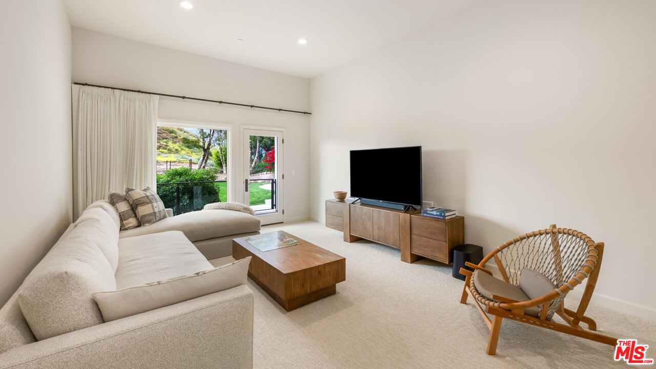 27445 Winding Way Malibu, CA 90265 - Photo 46 of 59 a living room with furniture and a flat screen tv