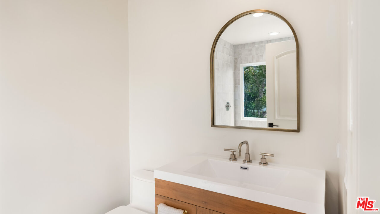 27445 Winding Way Malibu, CA 90265 - Photo 48 of 59 a bathroom with a sink and a mirror