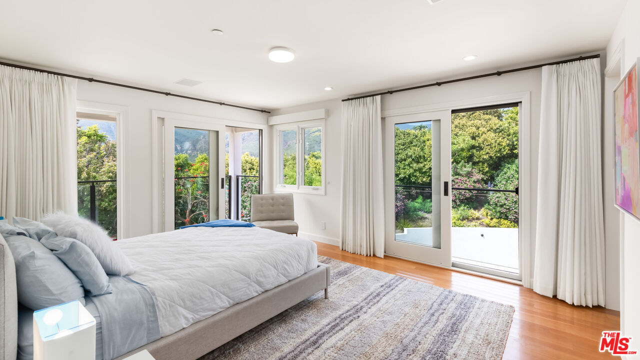 27445 Winding Way Malibu, CA 90265 - Photo 51 of 59 a bedroom with a large bed and a large window