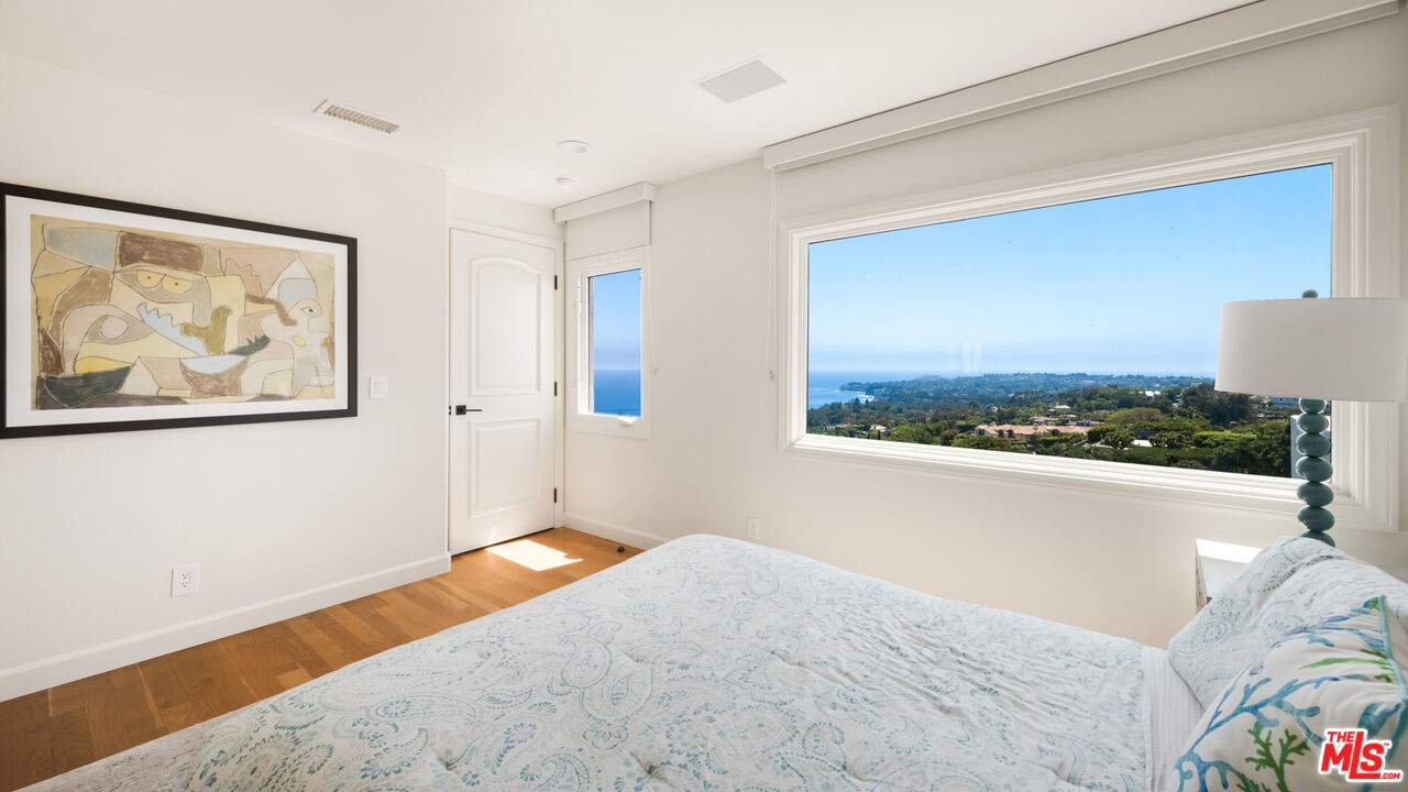 27445 Winding Way Malibu, CA 90265 - Photo 53 of 59 a bedroom with a bed and a painting on the wall