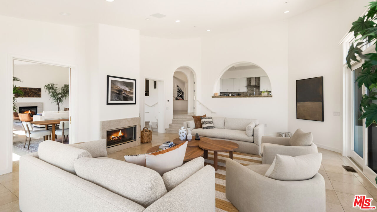 27445 Winding Way Malibu, CA 90265 - Photo 10 of 59 a living room with furniture a fireplace and a flat screen tv