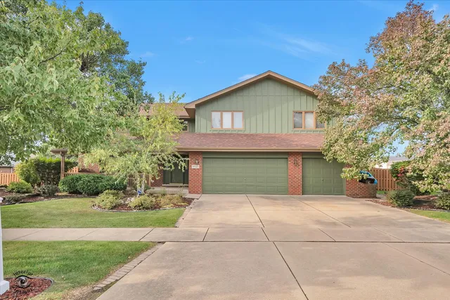 a front view of a house with yard and green space