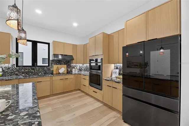 a view of a hallway with stairs and a chandelier