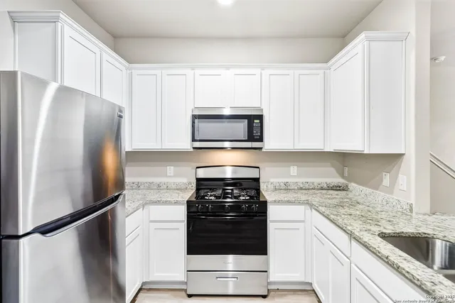 a kitchen with a sink stove and refrigerator