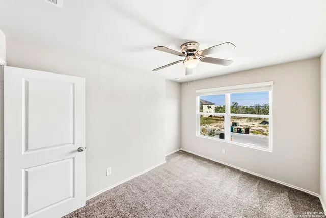a bedroom with a white bed and white walls