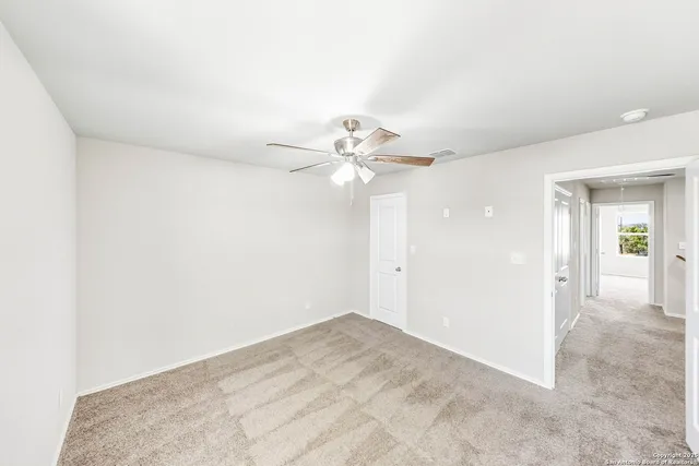 a view of a livingroom with a ceiling fan and window
