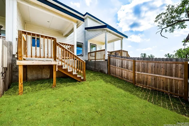 an aerial view of a house with garden space and deck