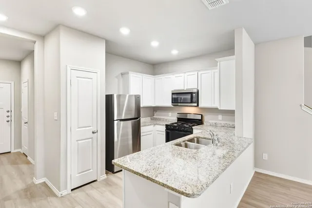 a kitchen with a refrigerator and a stove